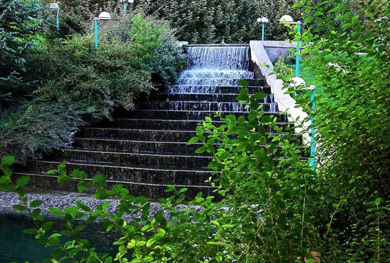 a waterfall at Goftogu Garden, one of the top 10 parks near Espinas Keshavarz Boulevard hotel in Tehran