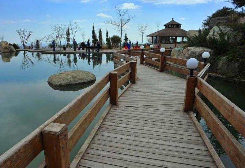 wooden bridges on artificial lake in Tehran Waterfall park